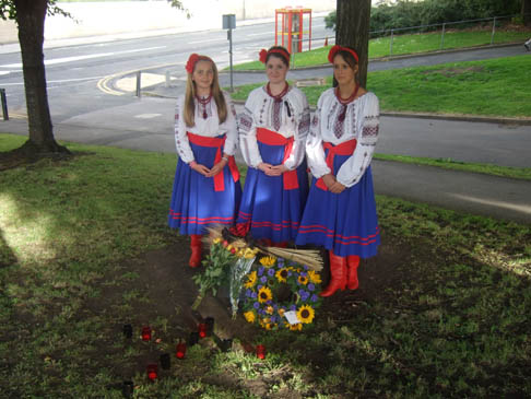 Sumivtsi standing by the commemorative plaque
